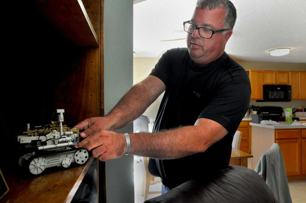 Dave Platt with the robot he built in the Army. Photo: Isaac Babcock