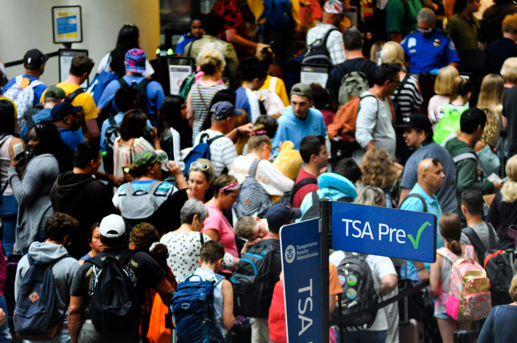 Passengers lineup outside of a TSA checkpoint at Orlando International Airport. Photo: Isaac Babcock